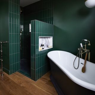 Green bathroom with tiles and bath