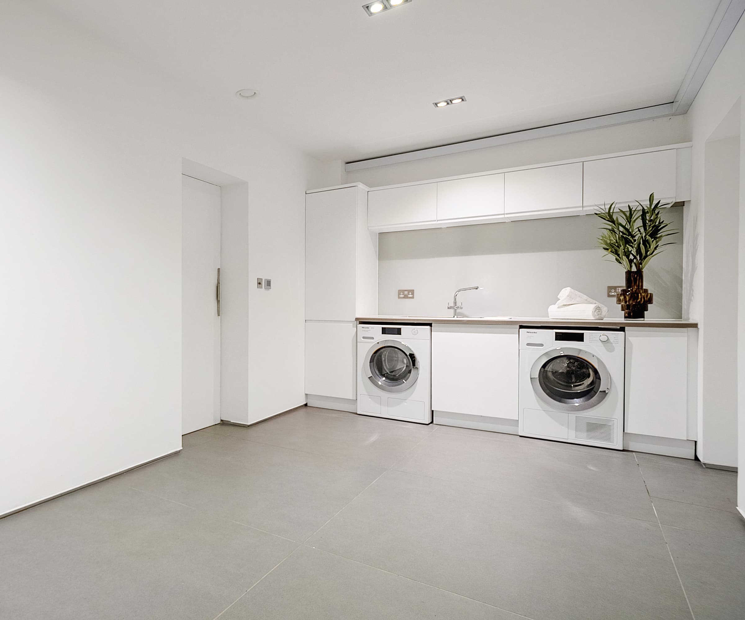 A white utility room connected to a garage