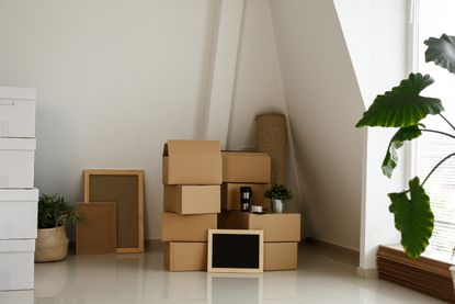 An empty living space with boxes stacked in preparation for moving