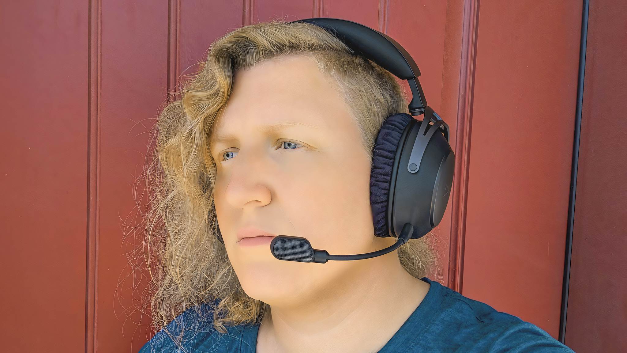 A woman wearing the HyperX Cloud Alpha 2 Wireless gaming headset.