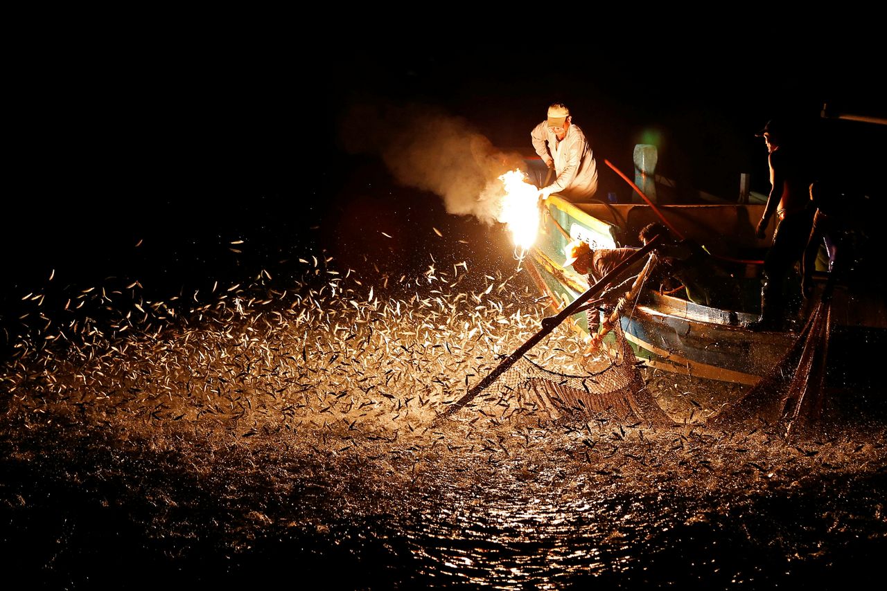 Fishermen use a fire to attract fish on a traditional “sulfuric fire fishing&amp;quot; boat in New Taipei City, Taiwan.