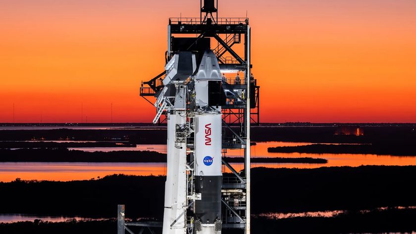 The Crew-10 Dragon capsule rests atop a SpaceX Falcon 9 rocket ahead of launch.