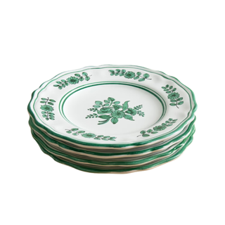 stack of four plates with green floral motif