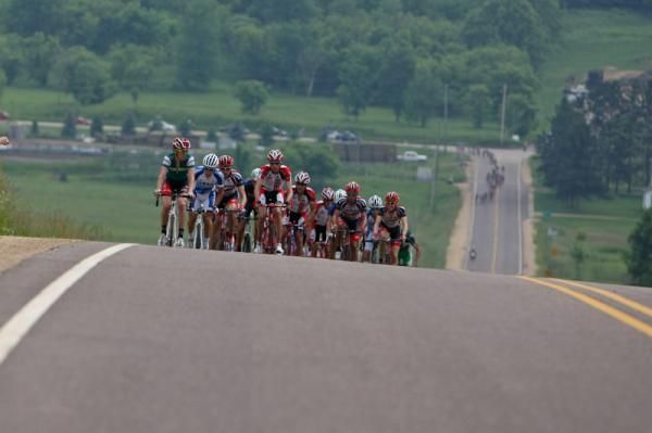 The large break goes up the road with the field in the distance.
