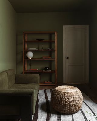 a green living room with a shelf