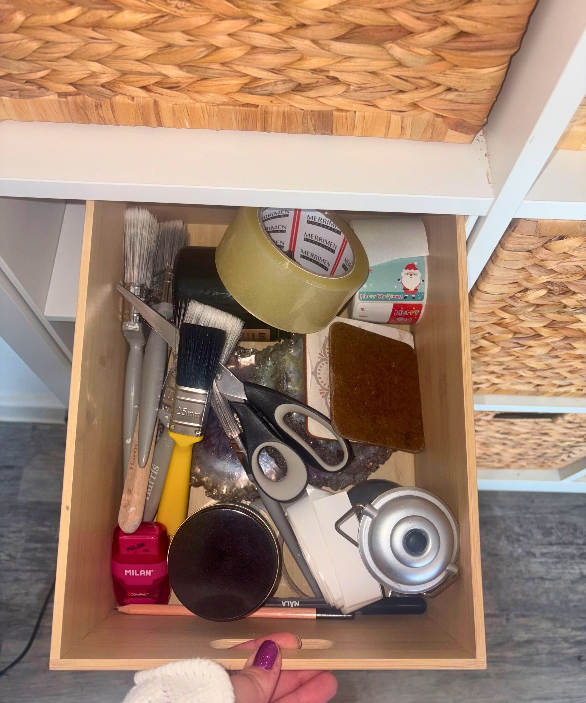 IKEA KALLAX drawer open in cube unit, showing kitchen utensils such as scissors