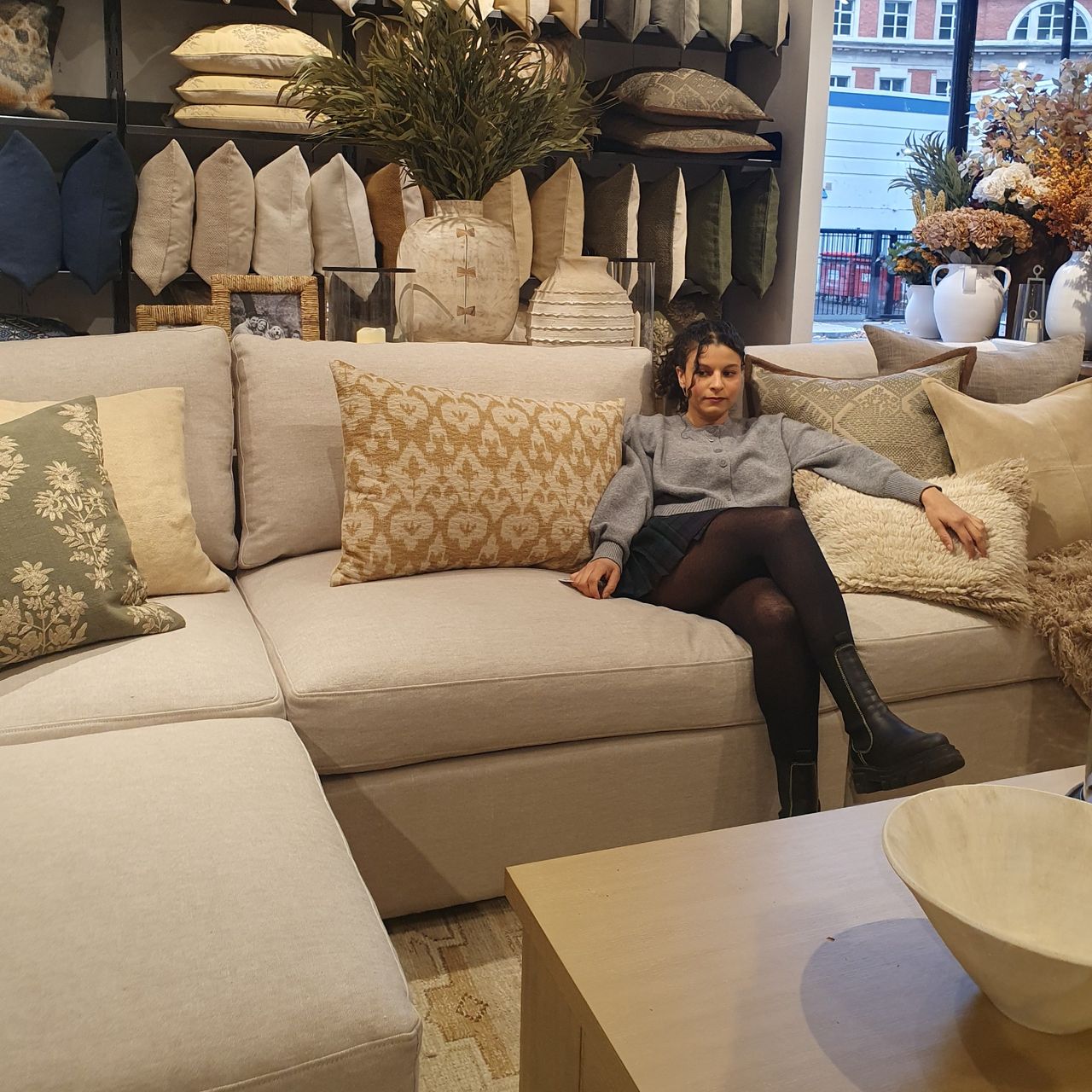 Sara sitting on Pottery Barn's Westwood sofa at the brand's pop up