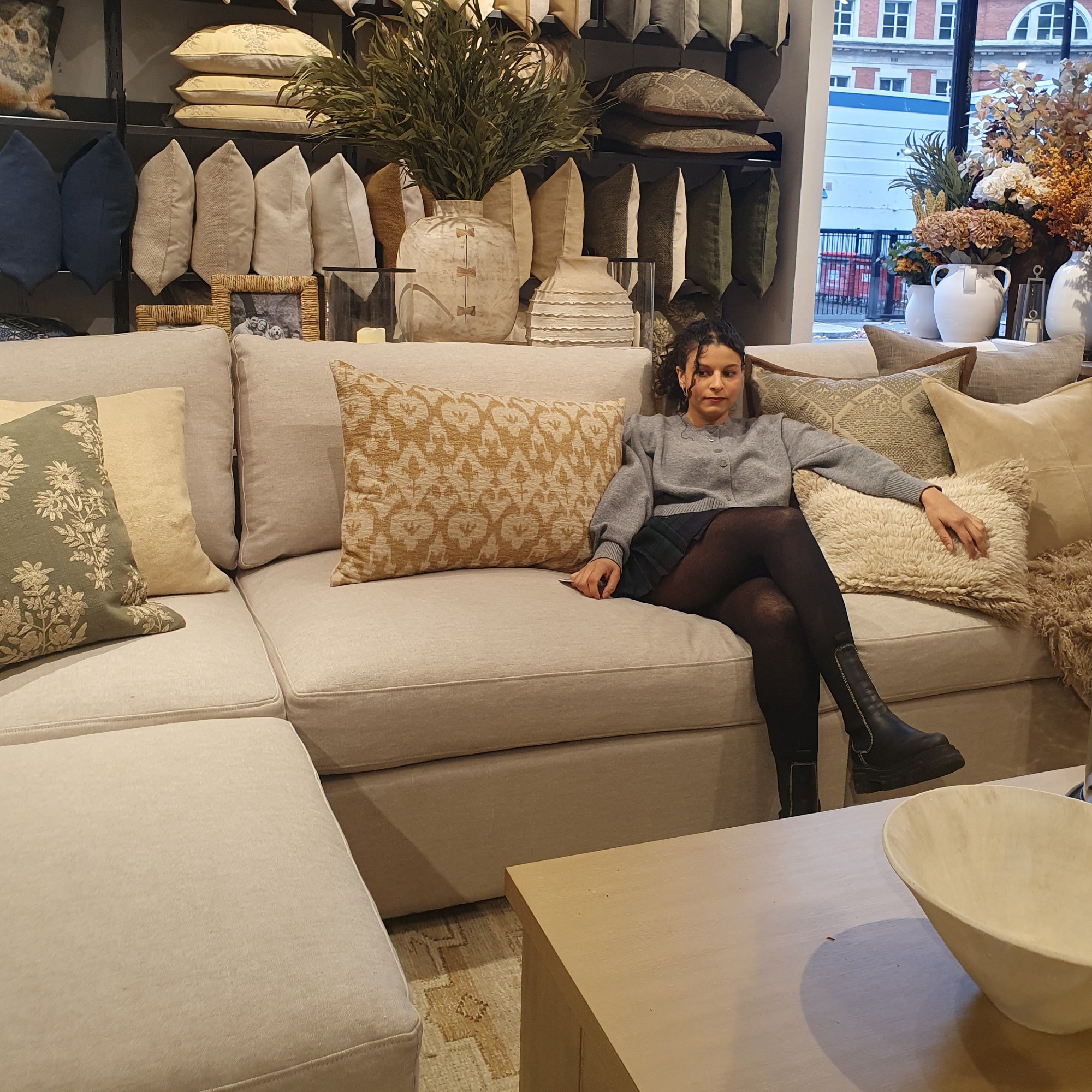 Sara sitting on Pottery Barn&#039;s Westwood sofa at the brand&#039;s pop up