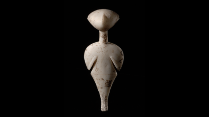 a human-like figurine made of white marble against a black background