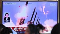 People sit near a television screen showing a news broadcast with file footage of a North Korean missile test, at a train station in Seoul on Sept. 20, 2026. North Korea fired a missile off its east coast on Sept. 20, South Korea's military said, days after Pyongyang reaffirmed its status as a nuclear-armed state.
