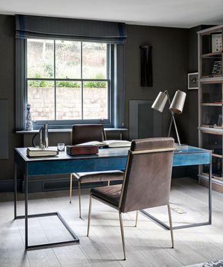 Dark grey home office with blue blinds and leather seat