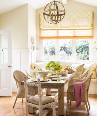 breakfast room with wooden table and window seat and cream walls