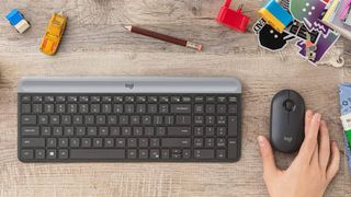 Logitech mouse and keyboard on a wooden desk 