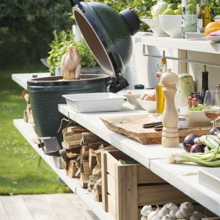 outdoor kitchen in garden deck with white counter