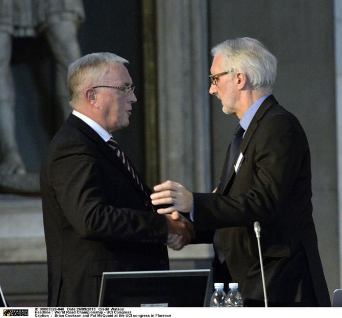 Outgoing UCI President Pat McQuaid shakes hands with incoming UCI President Brian Cookson