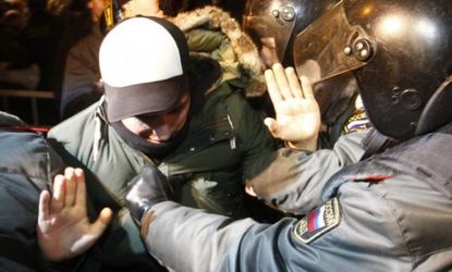 Police detain an activist during a rally Tuesday, as hundreds of Russian demonstrators protested the allegedly-fraudulent results of the country's parliamentary elections.