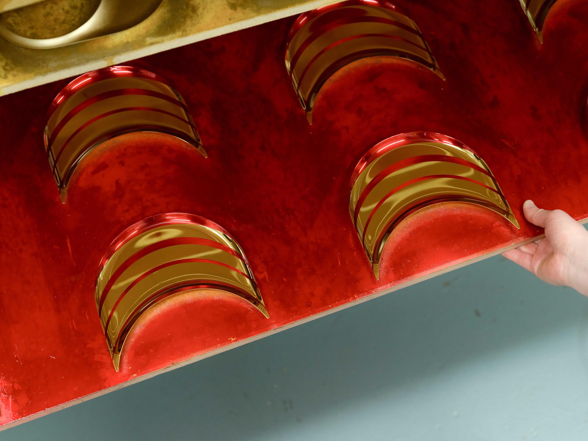 Gilded speaker parts on drying rack