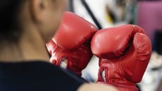 woman wearing red boxing gloves