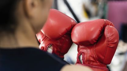 woman wearing red boxing gloves