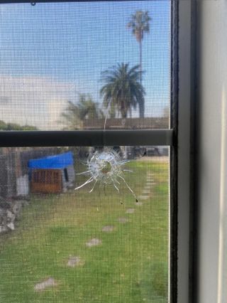 Damage of stray bullet in gamer's bedroom.
