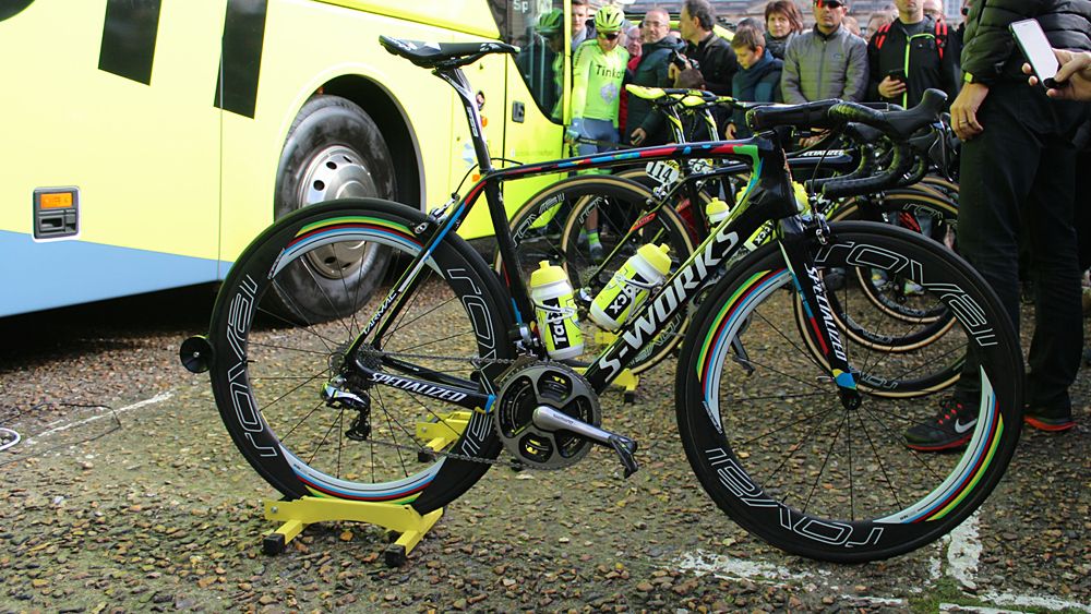 Note how all his teammates' bikes have numbers on them before the start