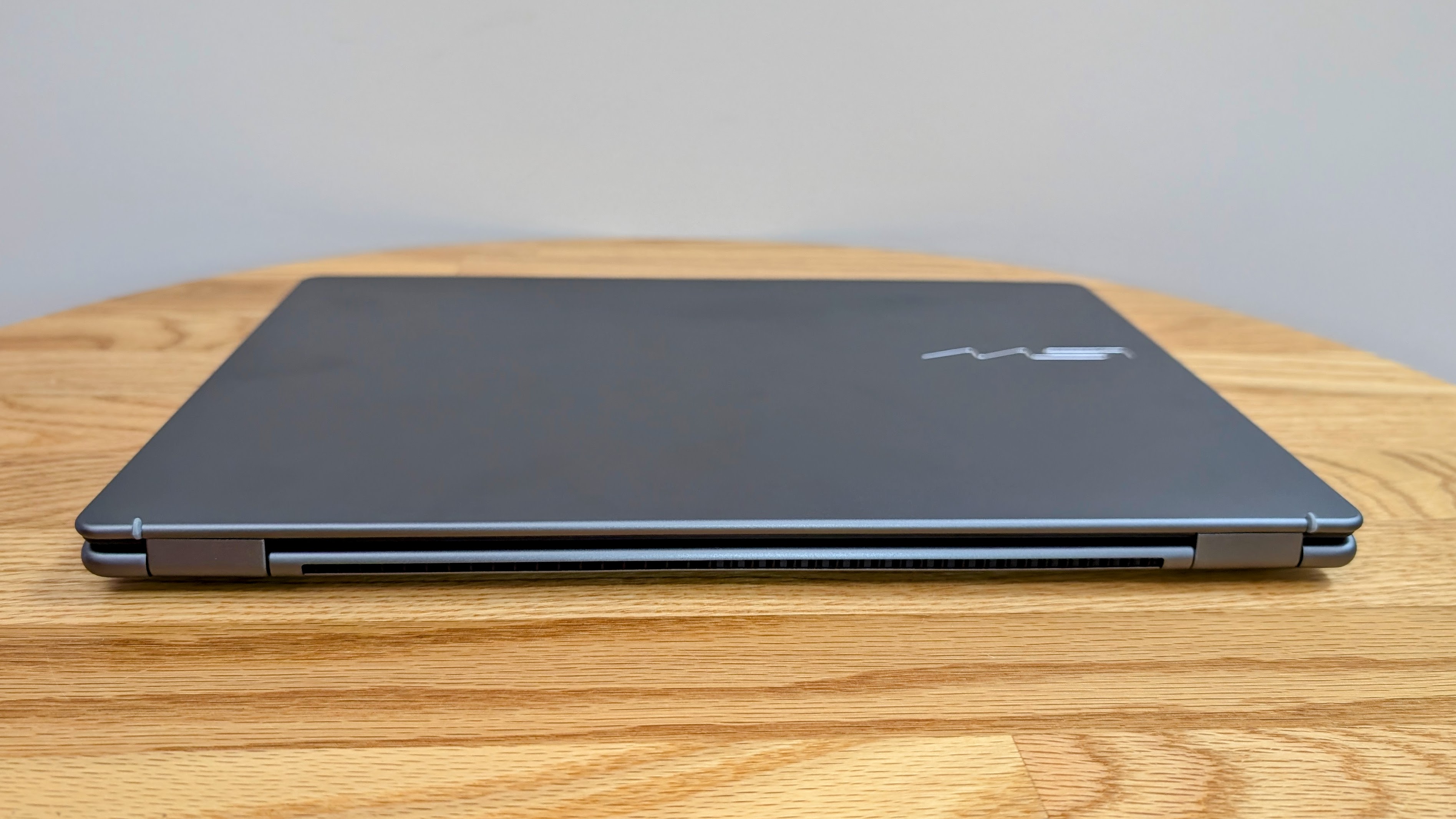 MSI Prestige 14 AI+ from the rear while closed on a coffee table