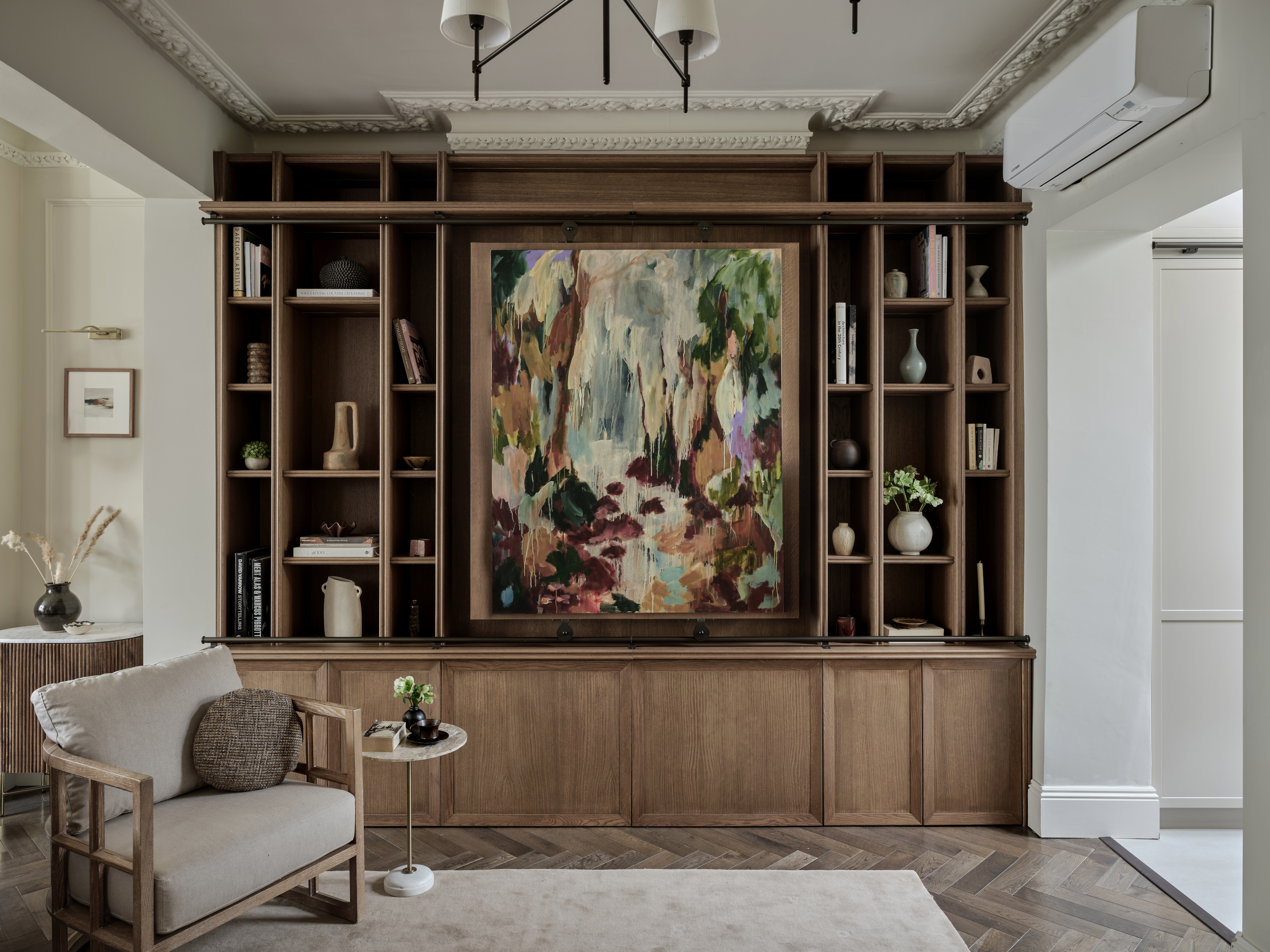 Wooden joinery with shelving, cupboard and artwork