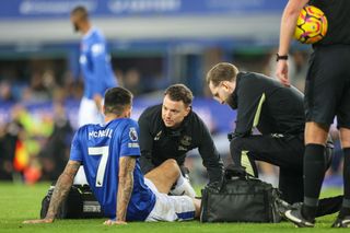 LIVERPOOL, ENGLAND - OCTOBER 26: Everton's Dwight McNeil receives treatment during the Premier League match between Everton and Fulham at Goodison Park on October 26, 2024 in Liverpool, England. (Photo by Alex Dodd - CameraSport via Getty Images)