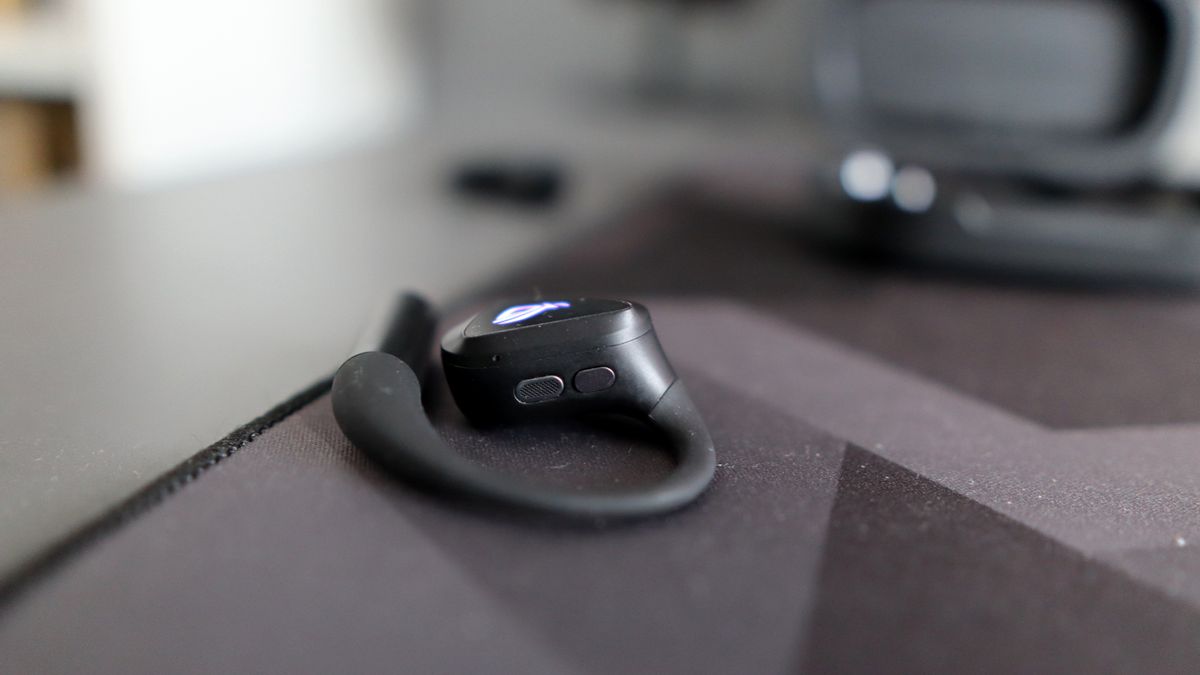 Asus ROG Cetra Open earbuds on a deskmat.