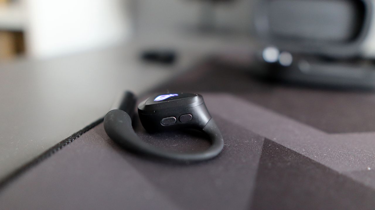Asus ROG Cetra Open earbuds on a deskmat.