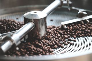 An image of coffee beans being roasted