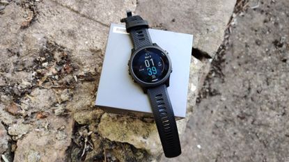Garmin Forerunner 945 review: Pictured here, the watch on the groun on top of its box