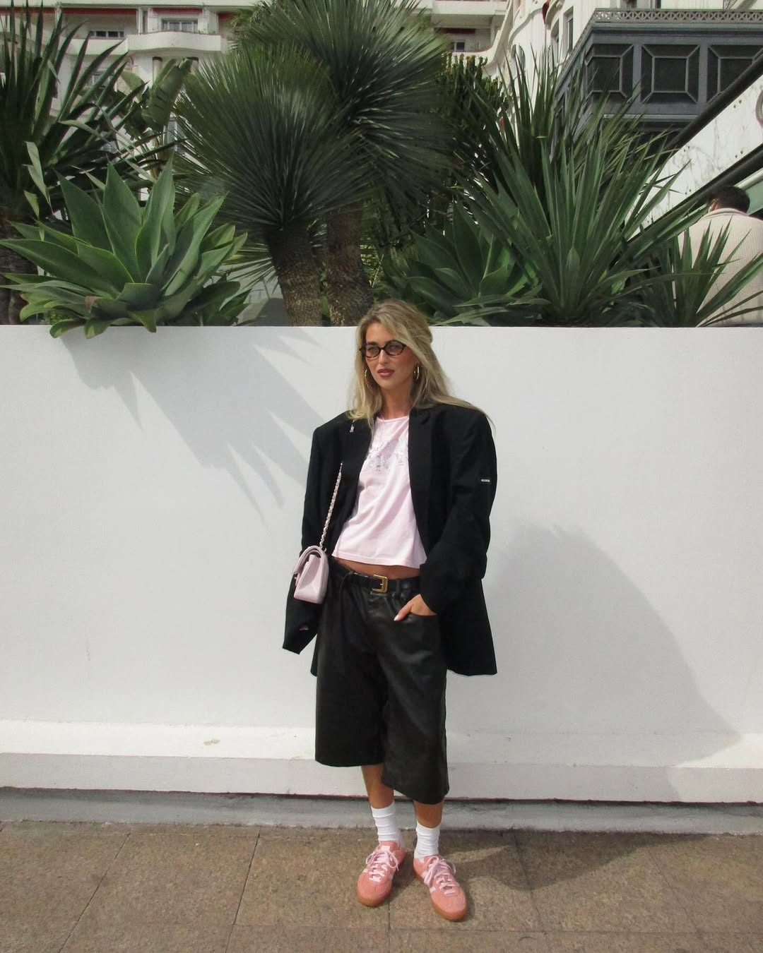 Emili in leather shorts and pink trainers