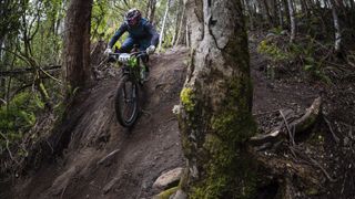 A front view of an Enduro mountain biker tackling a very steep descent