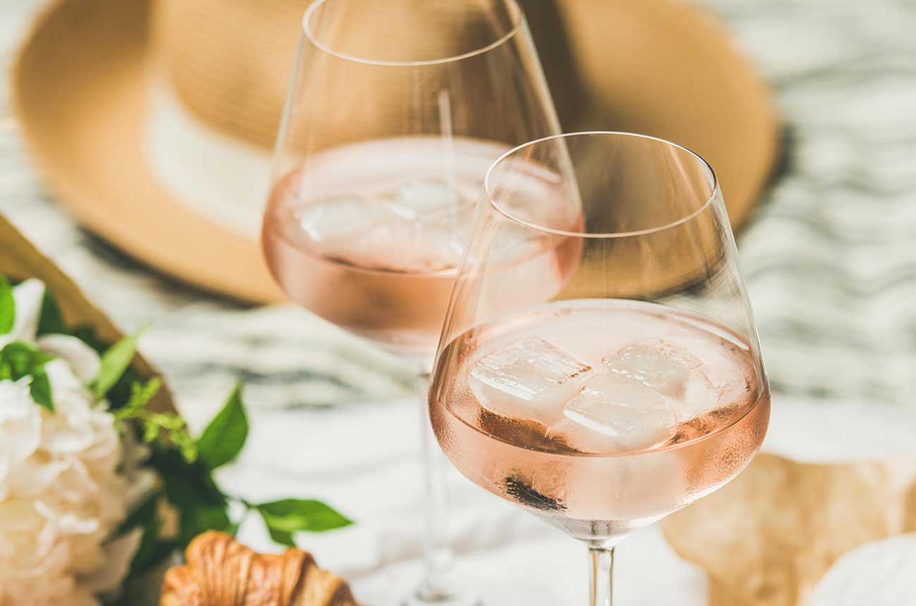 Two glasses of rose wine with ice cubes in