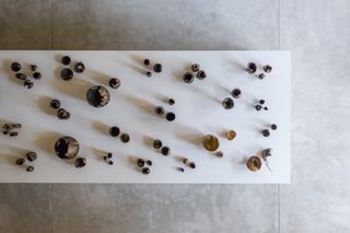 An overhead shot of vessels on a table inside the Carwan gallery