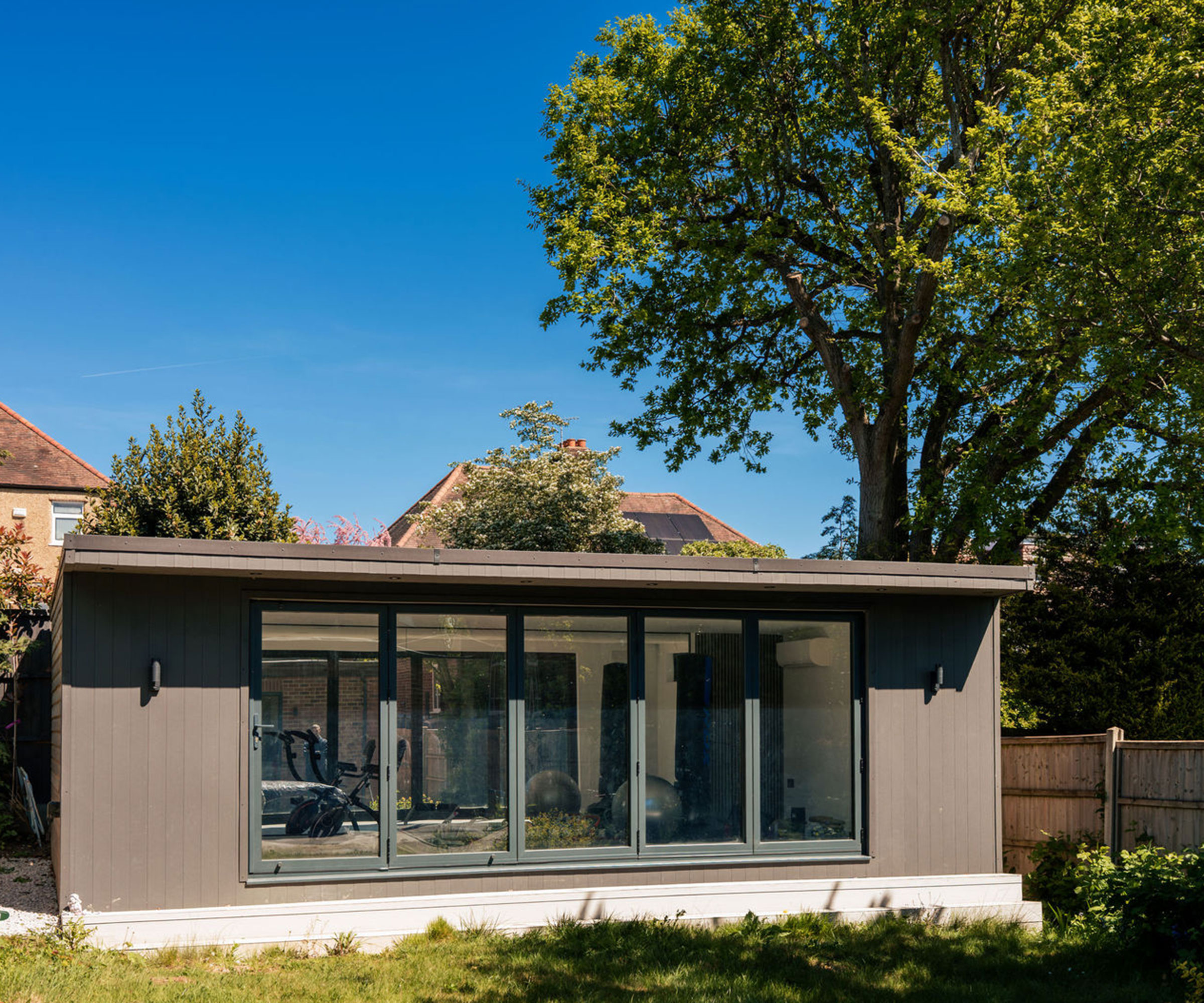 garden room with bifold doors and dark brown cladding