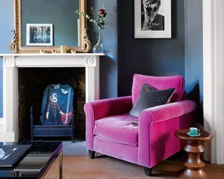 roost episode 5 - pink velvet chair in a dark blue living room with fireplace - paul massey