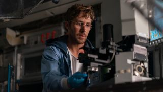 Ryan Gosling looking at a microscope in Project Hail Mary
