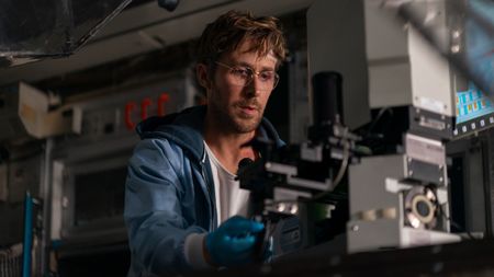 Ryan Gosling looking at a microscope in Project Hail Mary