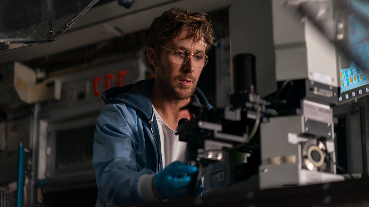 Ryan Gosling looking at a microscope in Project Hail Mary