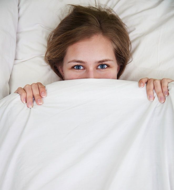 A woman sits in bed