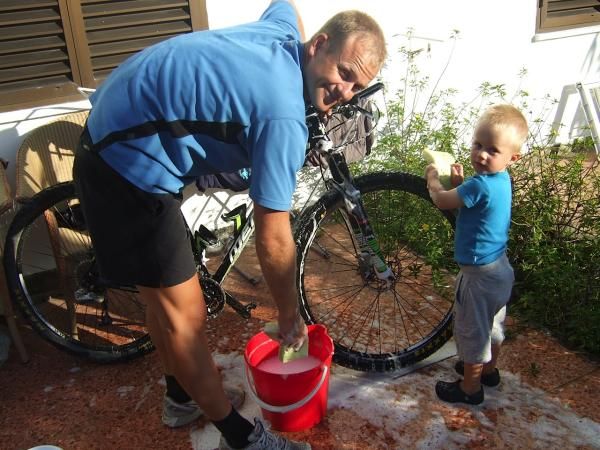 Bjornar works with daddy Kenneth on washing bikes