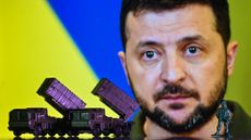 Illustration of a mini replica of MIM-104 Patriot, a surface-to-air missile (SAM) system, seen in front of a photo of Volodymyr Zelenskiy