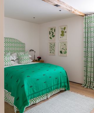 green and white country bedroom in 19th century Dorset barn conversion with colourful interior