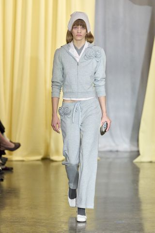 sandy liang moden in grey knit sweatshirt and grey knit pants