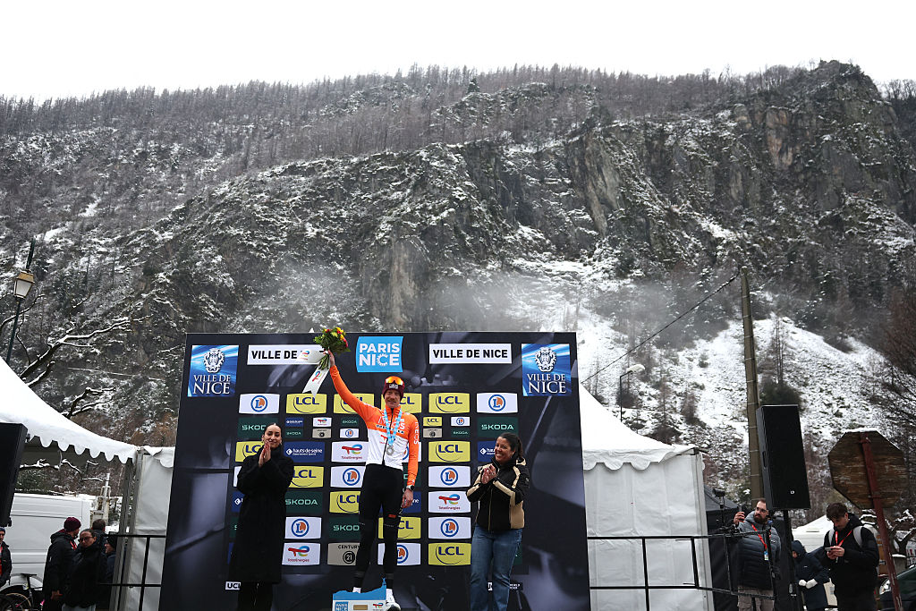 INEOS Grenadiers' French rider Dorian Godon celebrates on the podium after winning the 7th stage of the Paris-Nice cycling race, 47 km between Le Broc and Isola-Village, on March 14, 2026. Due to deteriorating weather conditions, the route of stage 7 has been changed to a 47 km race from Le Broc to Isola. (Photo by Anne-Christine POUJOULAT / AFP)