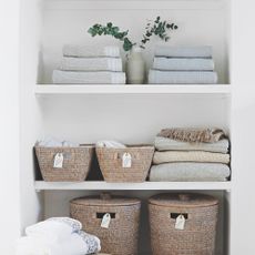 bathroom shelves with storage for towels and laundry