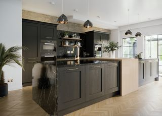 black kitchen with black worktops in modern design with gold tap