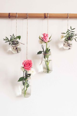 DIY glass bottles filled with roses for flower decoration